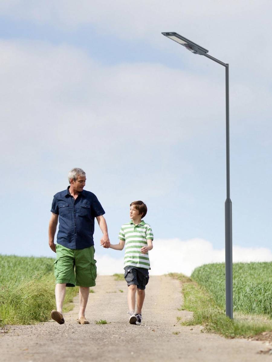 Solar street light over a residential pathway at dusk