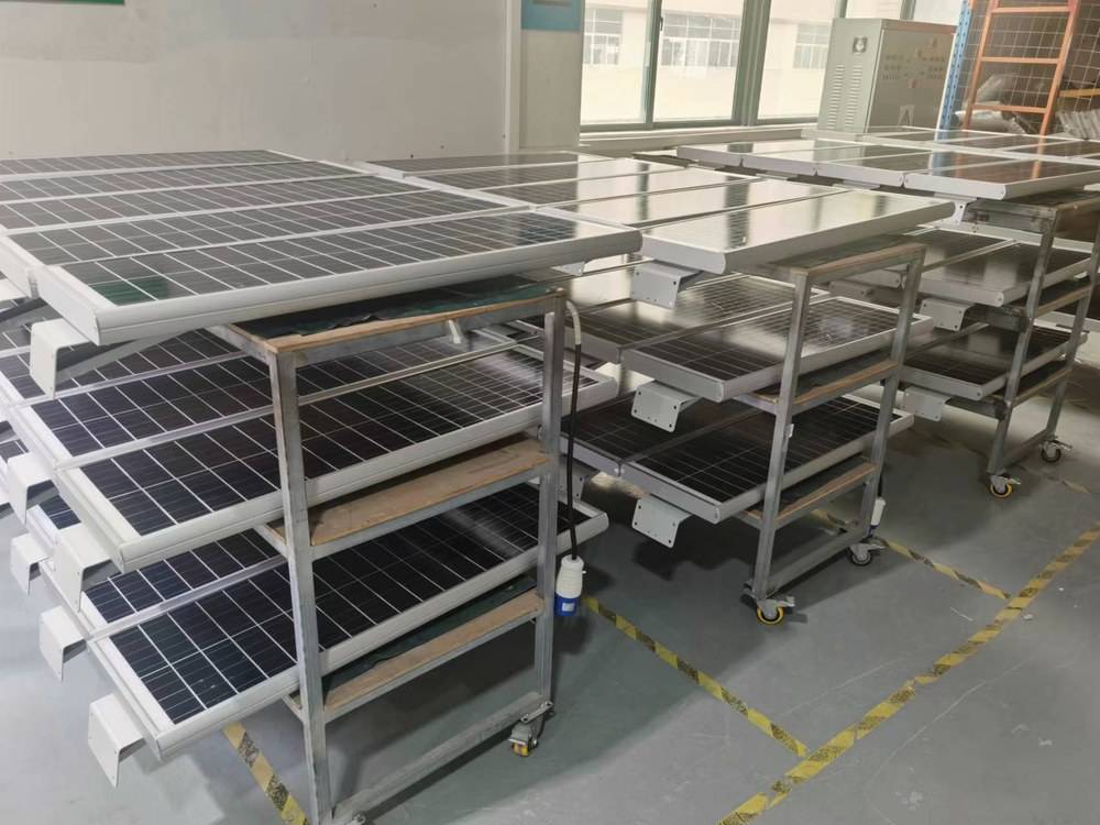 Solar panels staged in the workshop before assembly