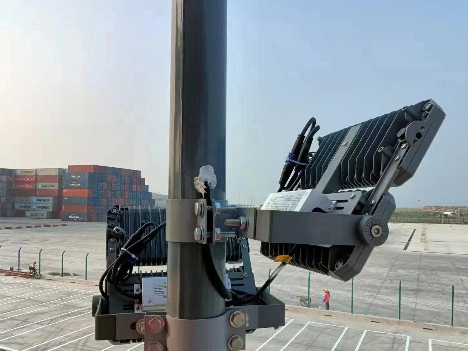 Floodlight bracket with floodlights mounted on a pole