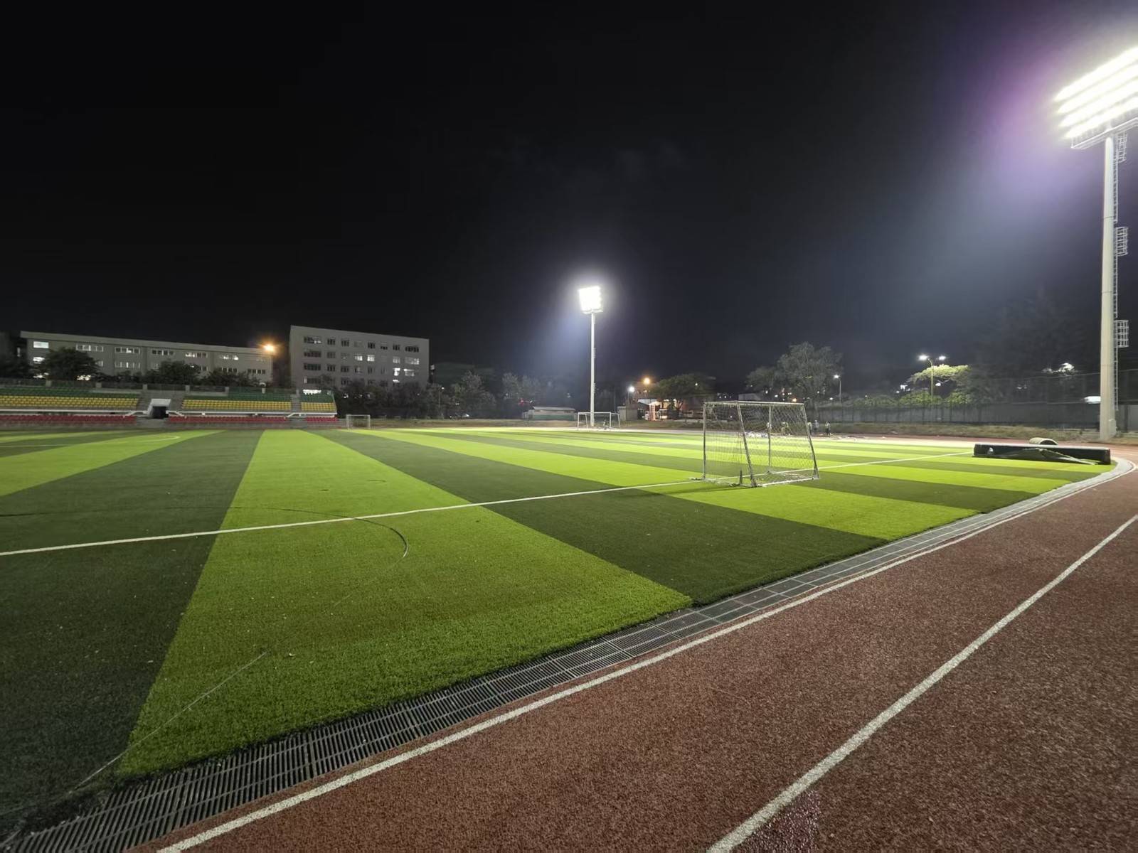 High mast floodlight lighting a football pitch at night